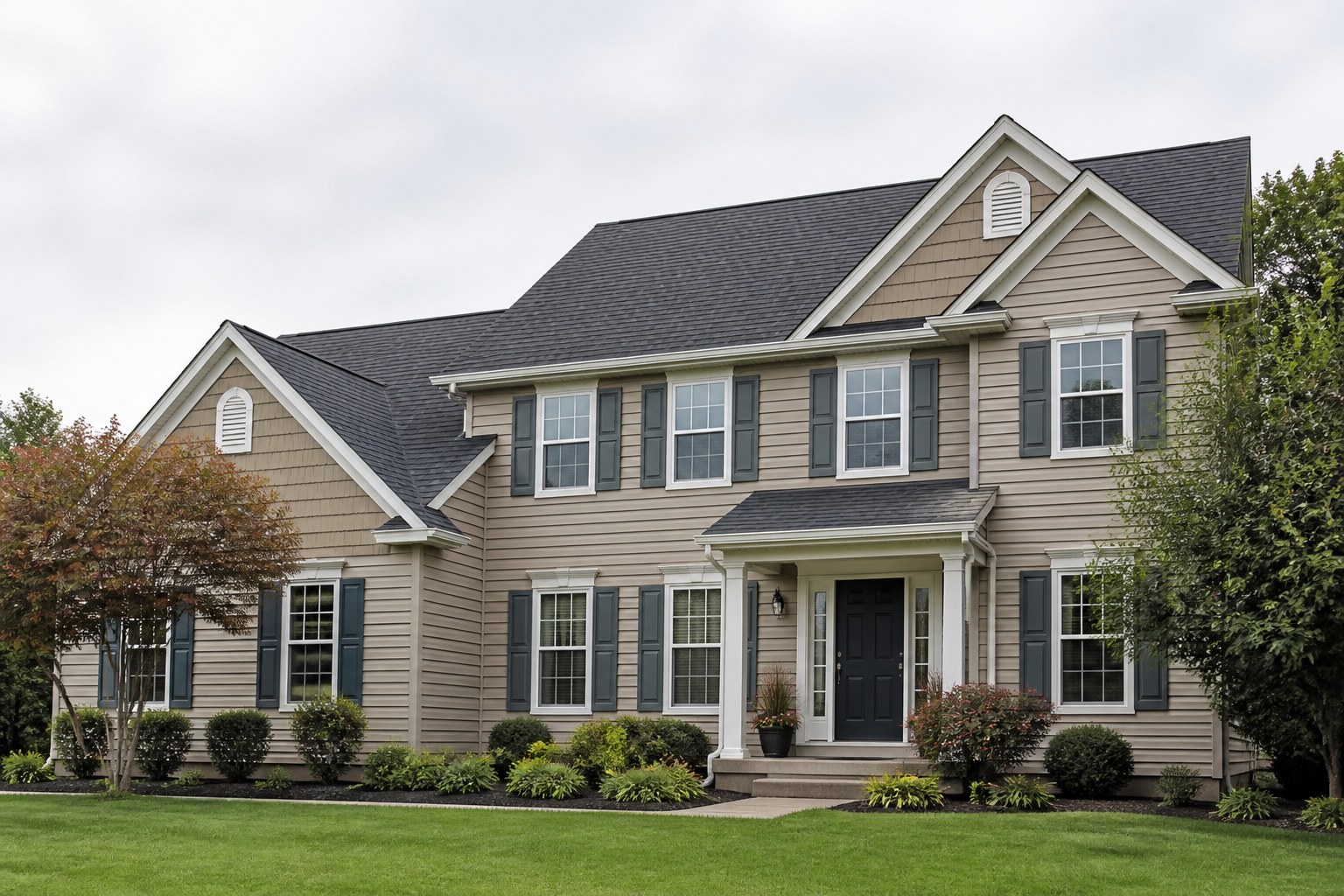 A classic American home with a front porch and navy shutters.